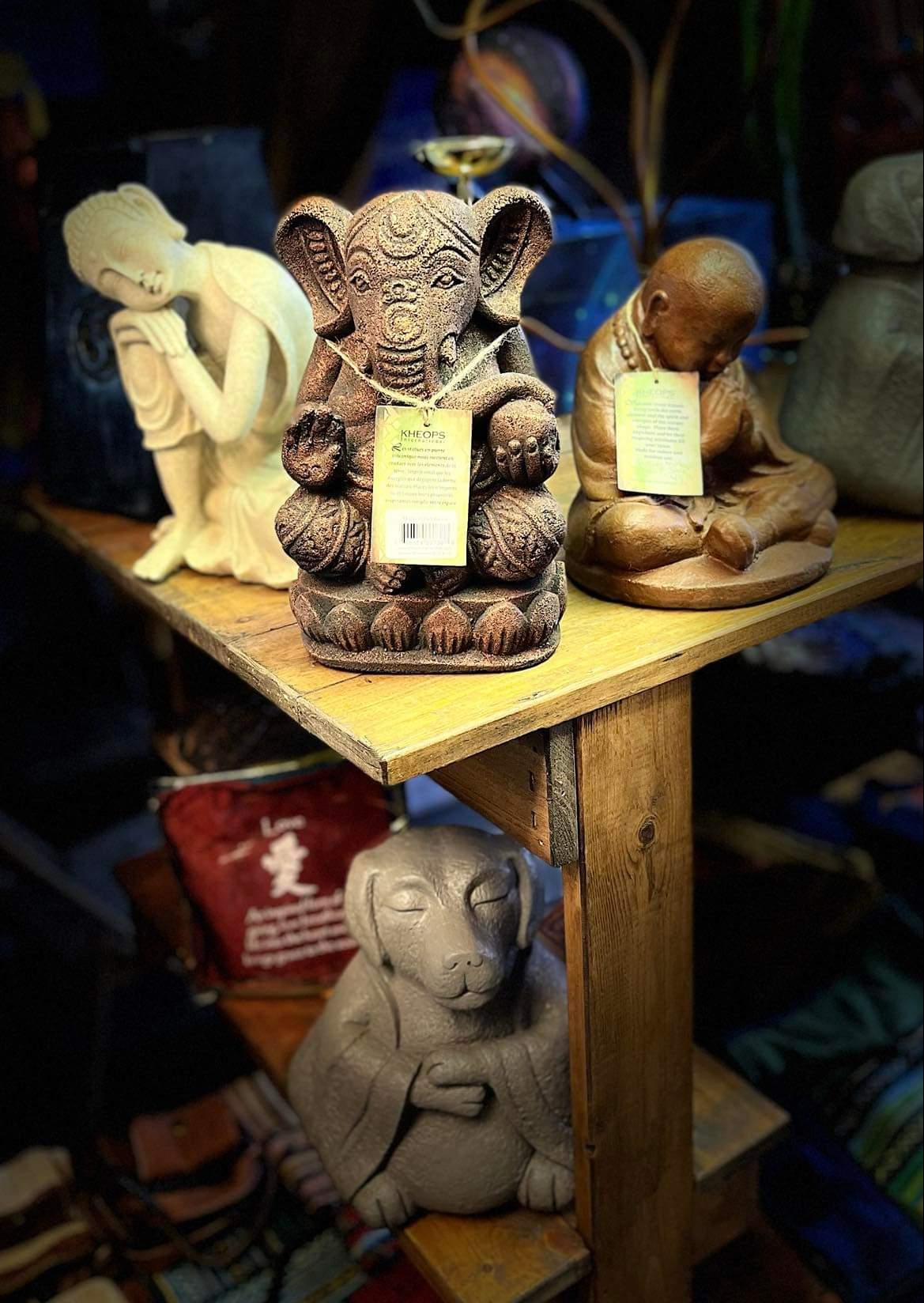 Carved Ganesha, Buddha and animal statuary on a wood table at Soul Seeker