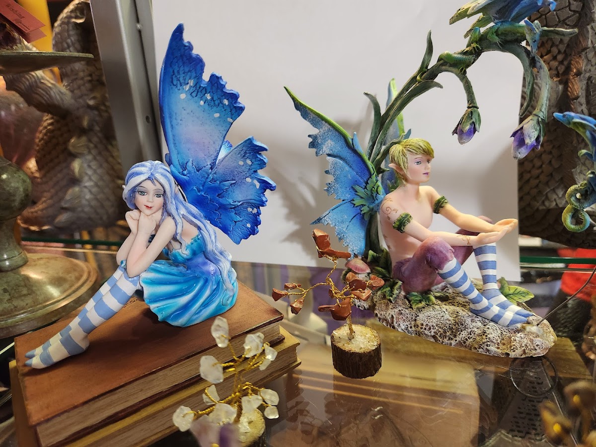 Blue fairy figurines on books with crystal accents at Soul Seeker
